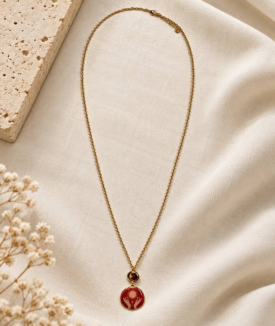 Collier avec pendentif mains rouge et détails dorés