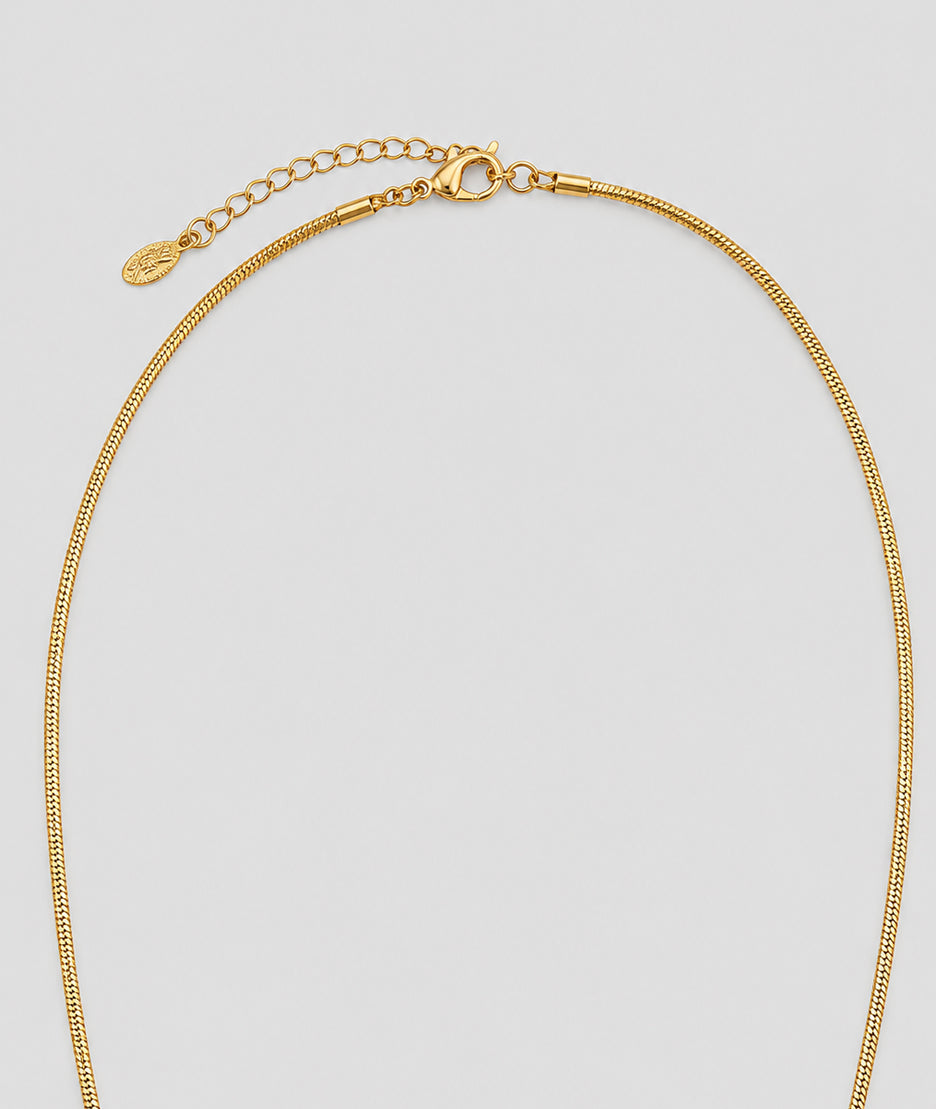 Collier Trèfle doré sautoir avec pendentif noir et franges — marque Carnaby